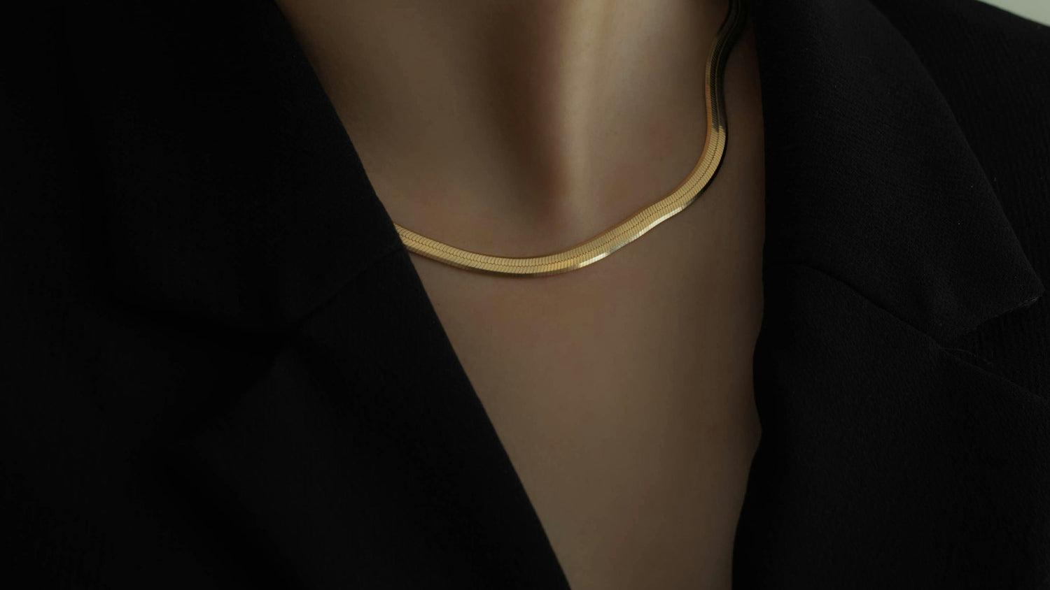 Everyoou modern luxe homepage hero — woman in black blazer wearing a personalized gold necklace